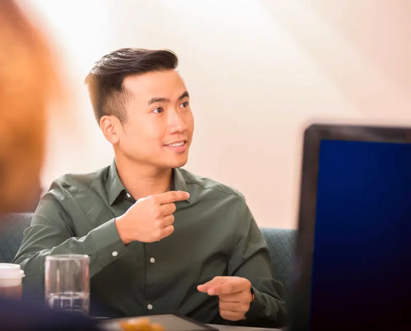 A BSL interpreter helps during an in-person meeting.